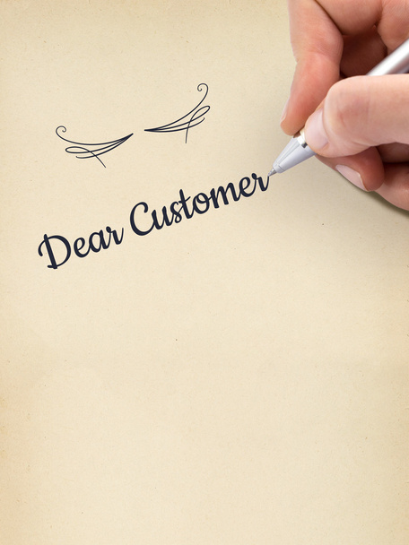Написання рук "Дорогий клієнт" на аркуші паперу у віці
. - Фото, зображення