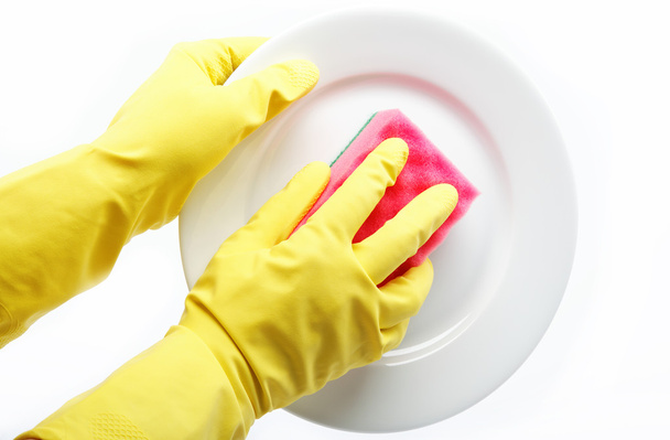 Hands in rubber gloves can sponge the plate on a white backgroun - Fotoğraf, Görsel