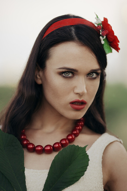 Ukrainian girl with a poppy in her hair - Fotó, kép