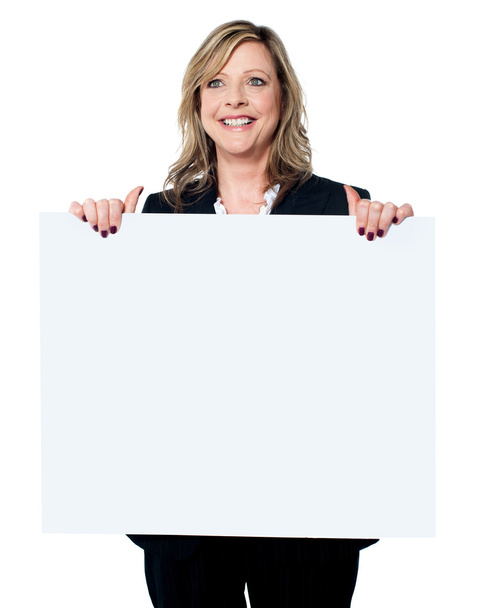 Female business professional holding blank billboard - Фото, зображення