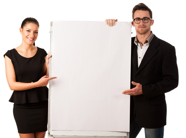 Confident business couple standing next to a big blank board to  - Fotó, kép