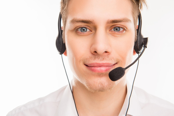 A close-up photo of smiling young agent of call centre - Foto, Bild