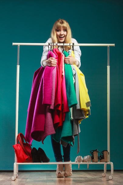 Funny woman taking all clothes in mall or wardrobe - Φωτογραφία, εικόνα