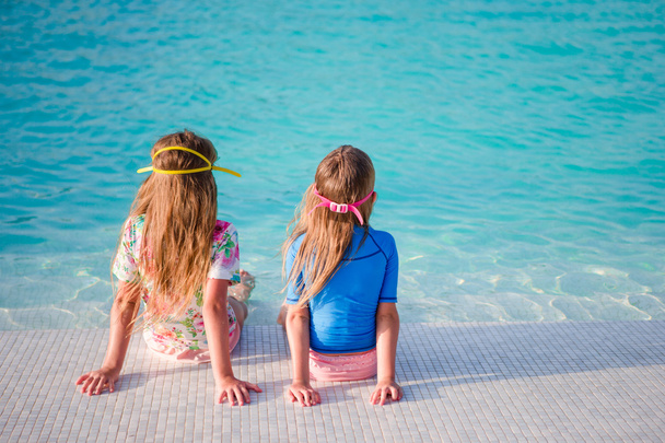 Adorable little girls in outdoor swimming pool - Photo, Image
