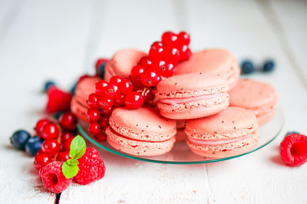 Raspberry macaroons with berries on wooden table - Photo, Image