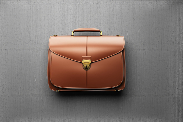 Briefcase on the background of gray concrete wall - Фото, изображение