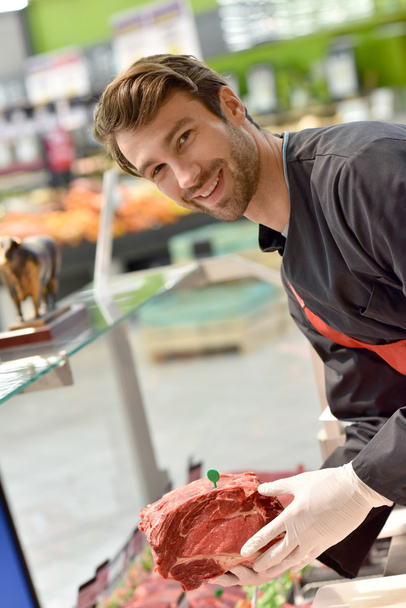 Butcher serving meat - Photo, image
