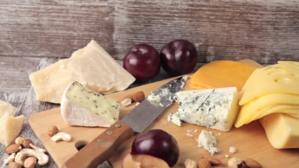 Med, ořechy, ovoce a sýr na dřevěné pozadí ve studiové fotografie - Záběry, video