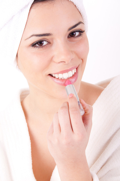 Woman applying lipstick - Foto, Imagen