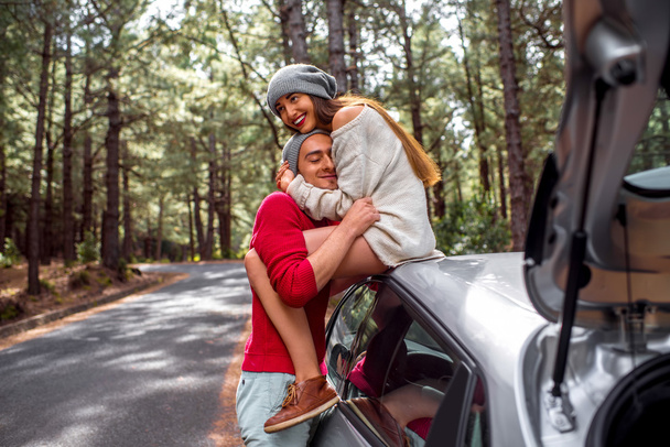 Молода пара подорожує на машині в лісі
 - Фото, зображення