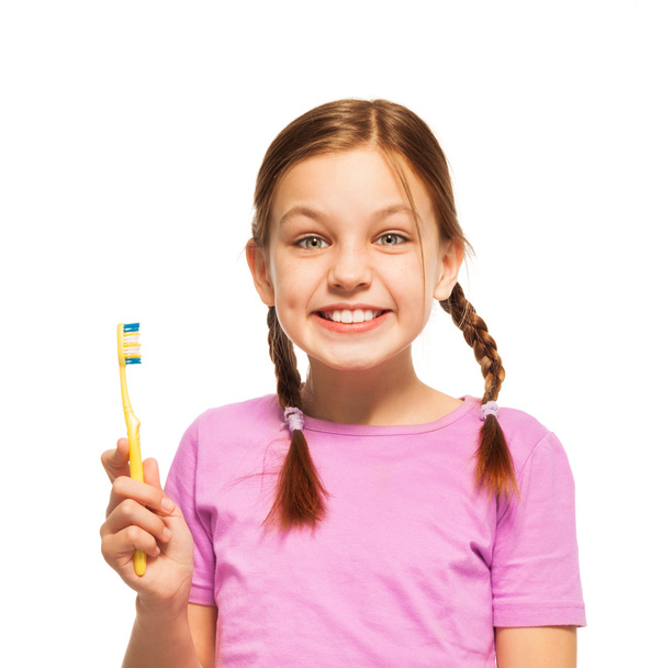 Funny teenage girl in pink tee brushing her teeth - Фото, зображення