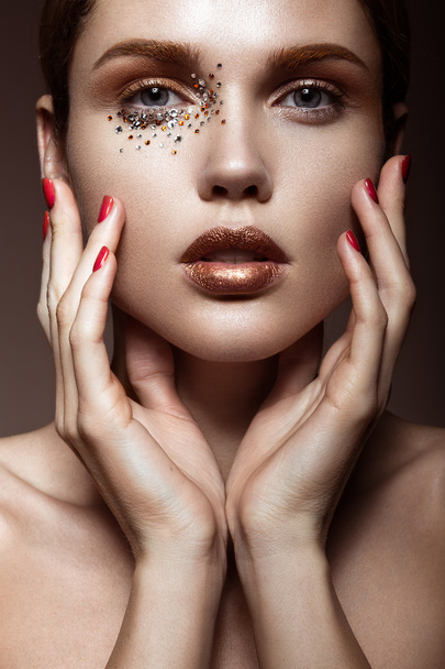 Beautiful girl with a gentle make-up and crystals on the face. - Zdjęcie, obraz