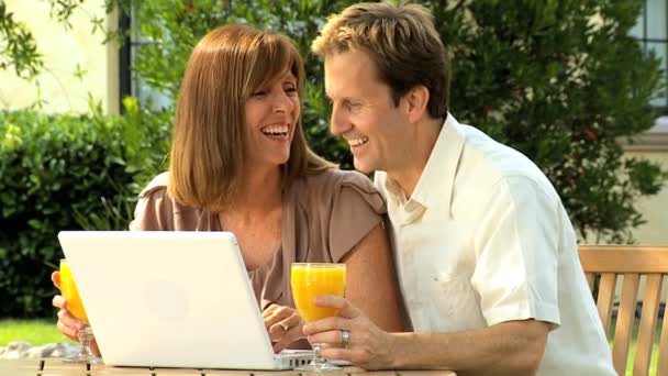 Couple at home garden with laptop computer - Footage, Video