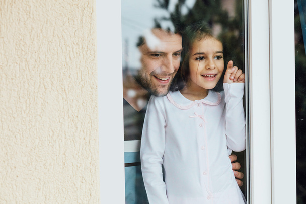 father and daugther looking outside - Photo, Image