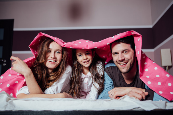 happy family under a blanket - Фото, изображение