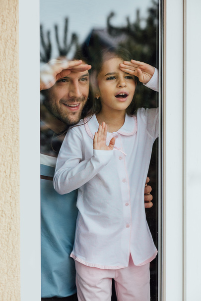 father and daugther looking outside - Foto, Imagen