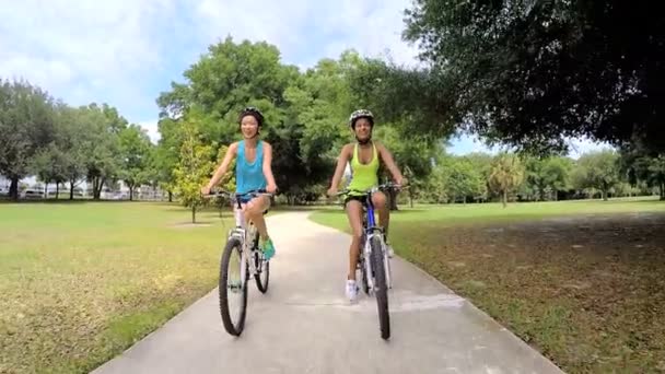 multi ethnic women riding bicycles in park - Footage, Video