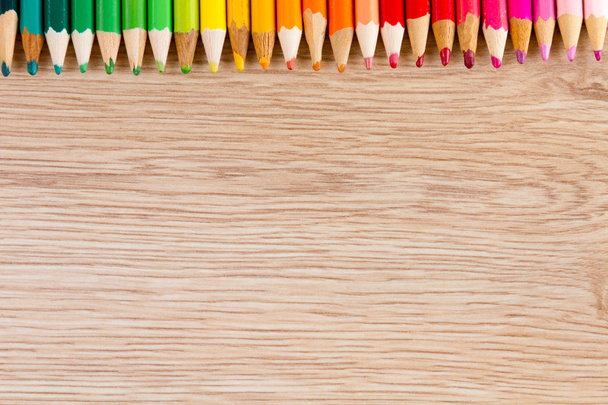 Colorful row of pens on wooden table - Photo, Image