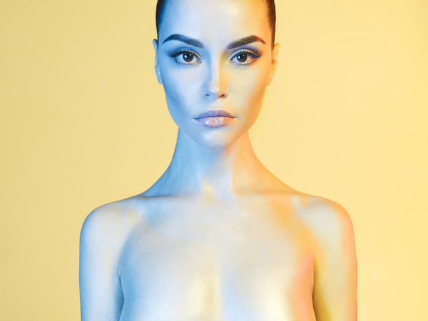 Elegant model in the light colored spotlights - Zdjęcie, obraz