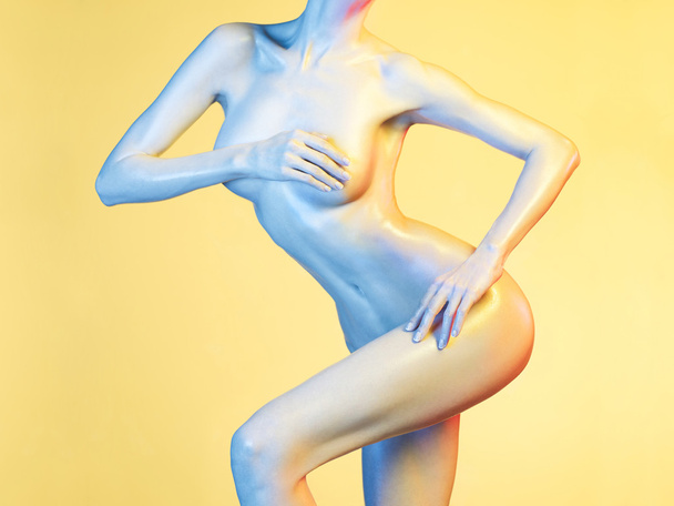 Elegant nude model in the light colored spotlights - Фото, изображение