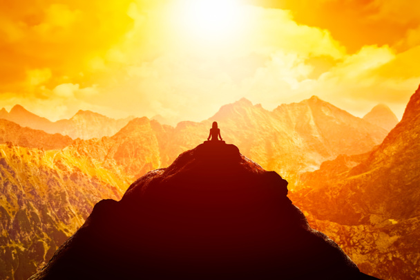 Woman meditating on the top of a mountain - Photo, Image