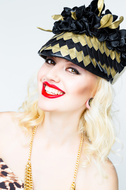 Young blonde woman in extravagant hat - Fotoğraf, Görsel