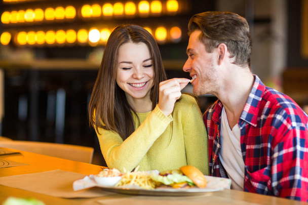 Man is feeding woman in cafe - Photo, Image