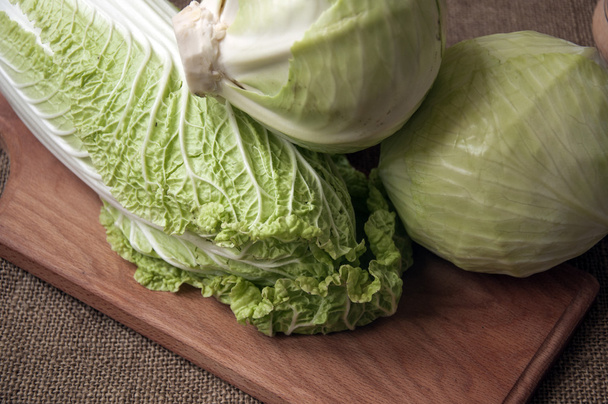 cabbage on a wooden board on a background sacking, burlap - Foto, Bild