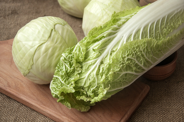 cabbage on a wooden board on a background sacking, burlap - Zdjęcie, obraz