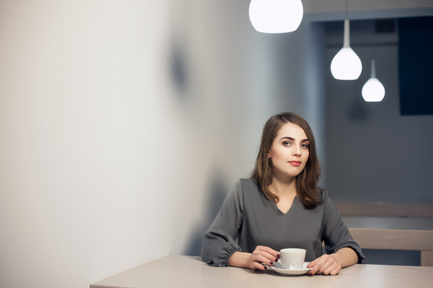 young adult female has coffee break in cafe; - Zdjęcie, obraz