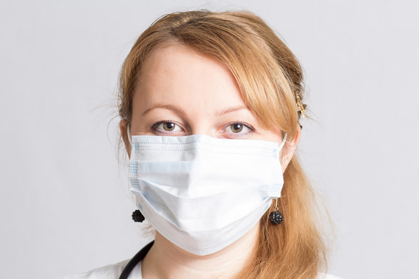 Beautiful woman doctor  in a protective mask - Fotoğraf, Görsel