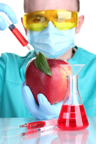 Scientist injecting GMO into the apple - Photo, image