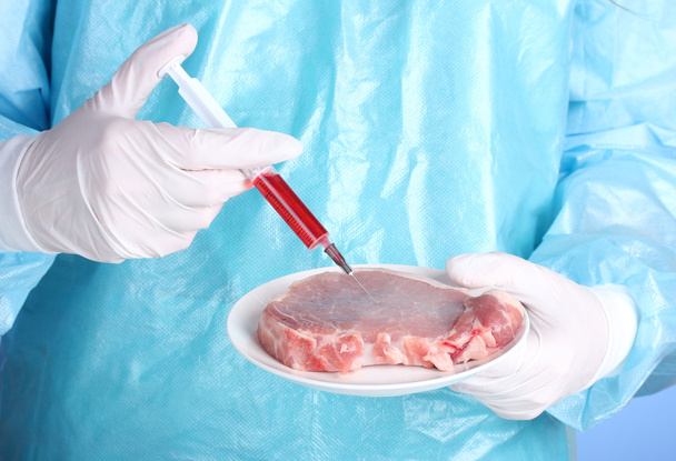 A scientist holds a genetically modified meat - Foto, Imagem