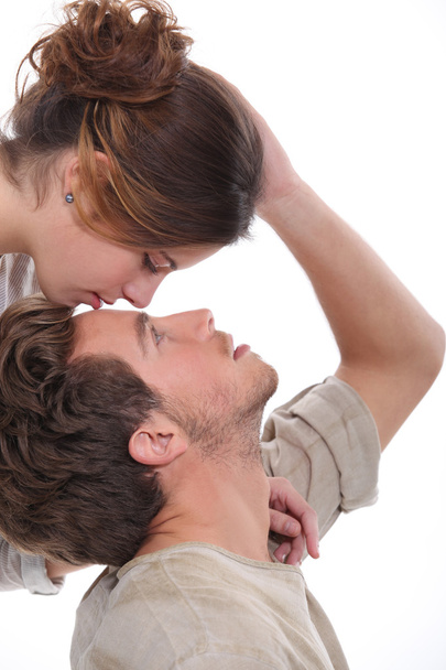 Woman kissing man on the forehead - Фото, изображение