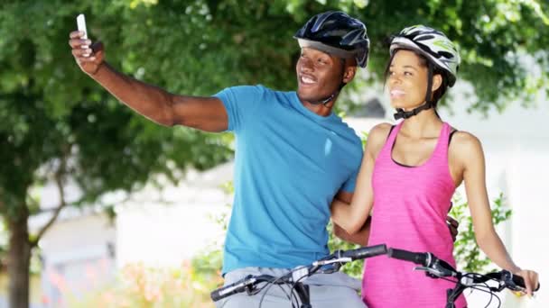 couple taking selfie while riding bicycles - Footage, Video