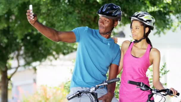 couple taking selfie while riding bicycles - Footage, Video