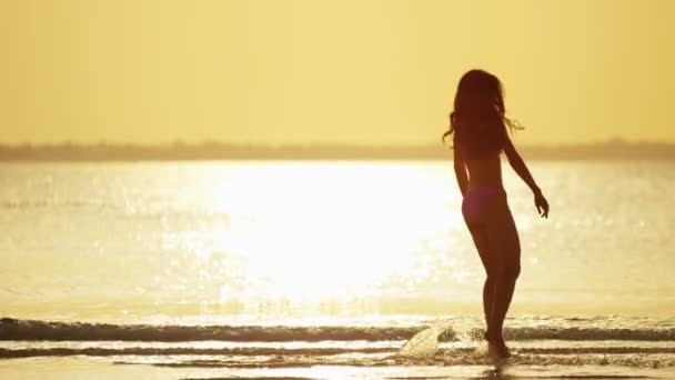 Chinese girl in bikini dancing on beach - Footage, Video