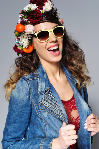 Beautiful woman in flower crown wearing sunglasses - 写真・画像