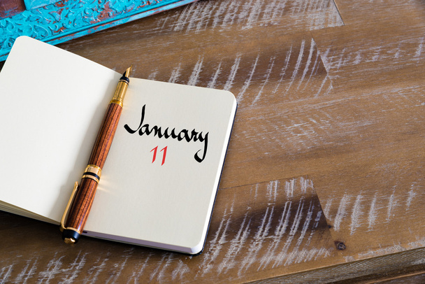 Január 11-én kézzel notebook naptári nap - Fotó, kép