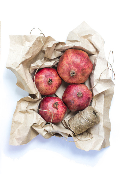 Pomegranate wrapped in craft paper - 写真・画像