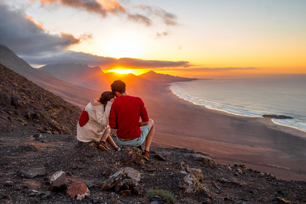 フェルテベントゥラ島の美しい夕日を楽しむカップル - 写真・画像