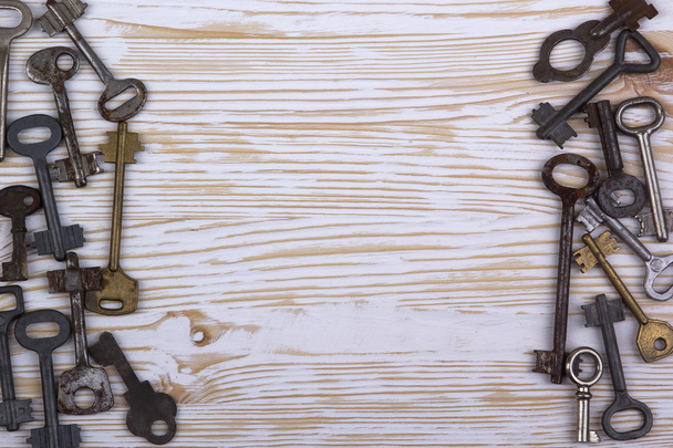 Old keys on wooden background - Photo, Image