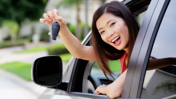 Asian girl in car showing car key - Footage, Video