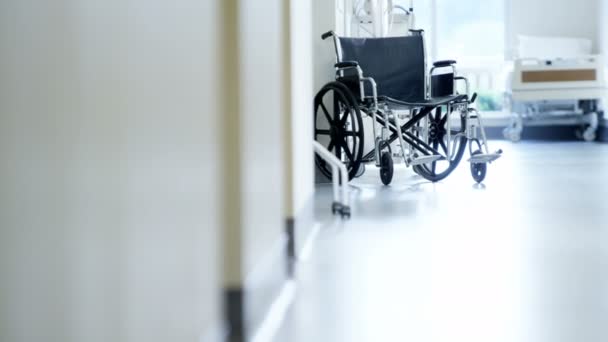 wheelchair for disabled patient in hospital corridor - Video, Çekim