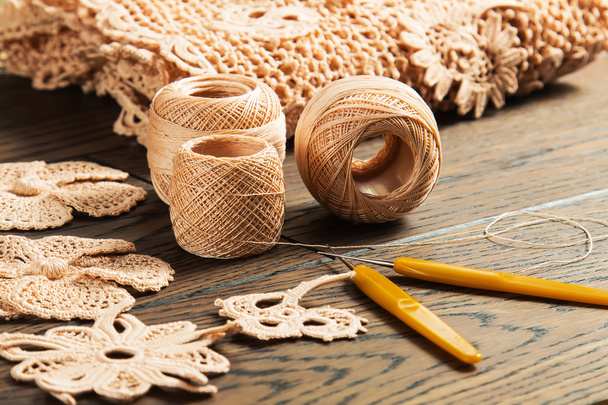 beautiful yarn Irish lace on the wooden background - Foto, imagen