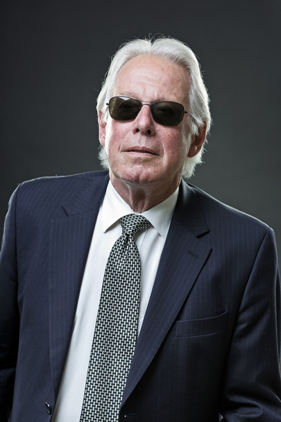 Senior business man wearing dark blue suit and black sunglasses. - Foto, imagen