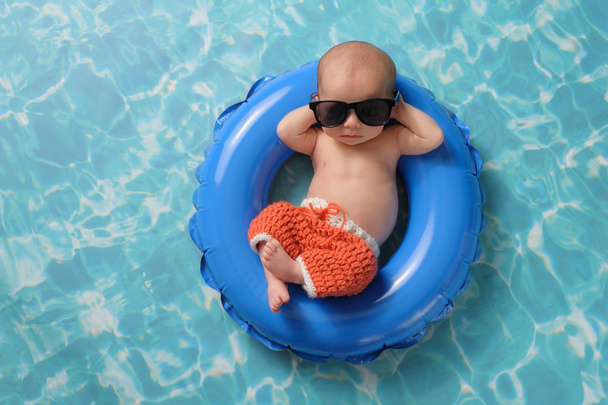 Newborn Baby Boy Floating on an Inflatable Swim Ring - Photo, Image