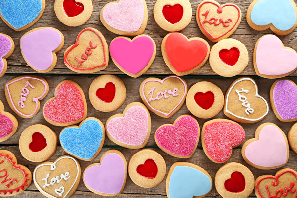 Assortment of love cookies on wooden background, closeup - 写真・画像