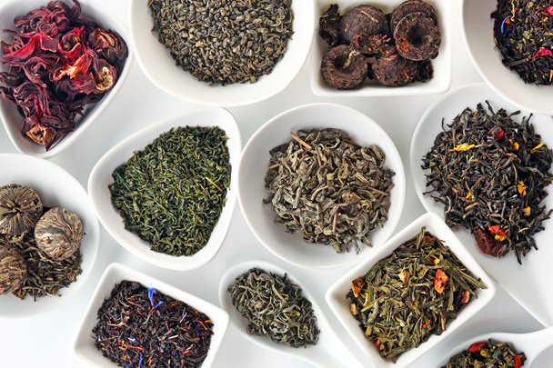 Variety of dry tea in bowls and spoons, closeup - Zdjęcie, obraz
