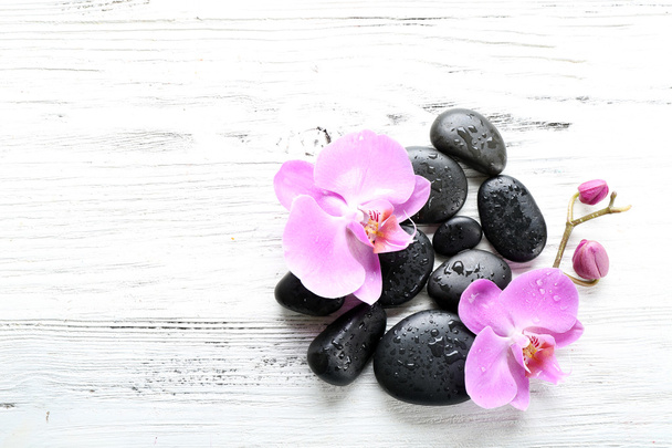 Beautiful composition of orchid and pebbles - Photo, image